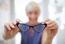 Woman holding up glasses